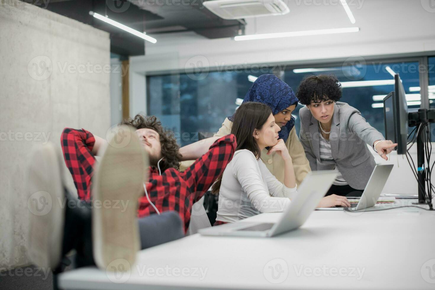 software developer resting with legs on desk photo