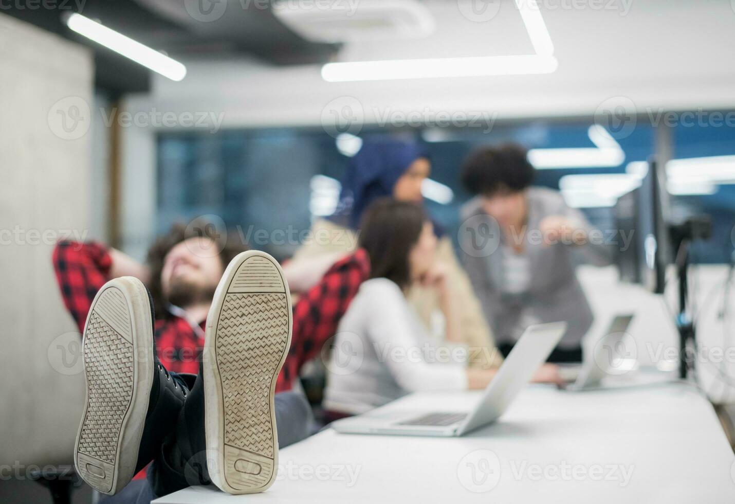 software developer resting with legs on desk photo