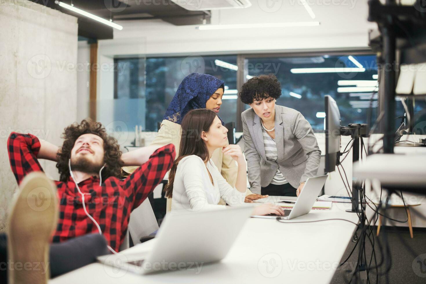 software developer resting with legs on desk photo