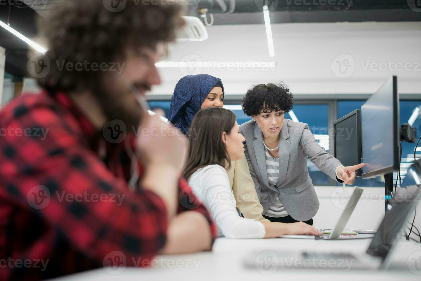 young multiethnics team of software developers working together photo