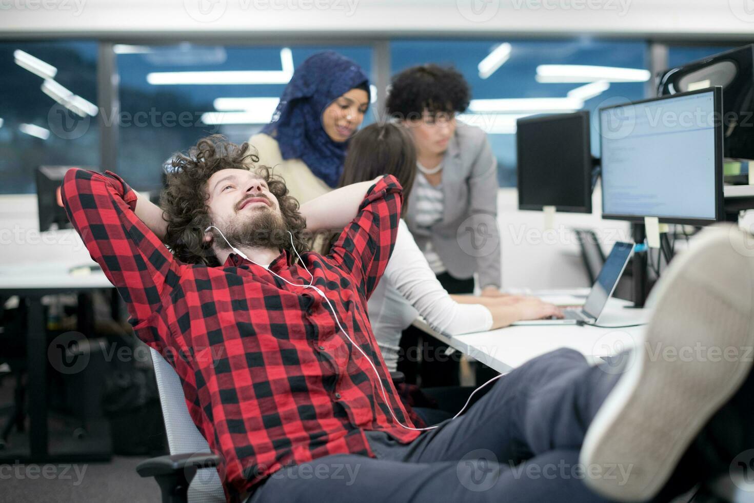 software developer resting with legs on desk photo