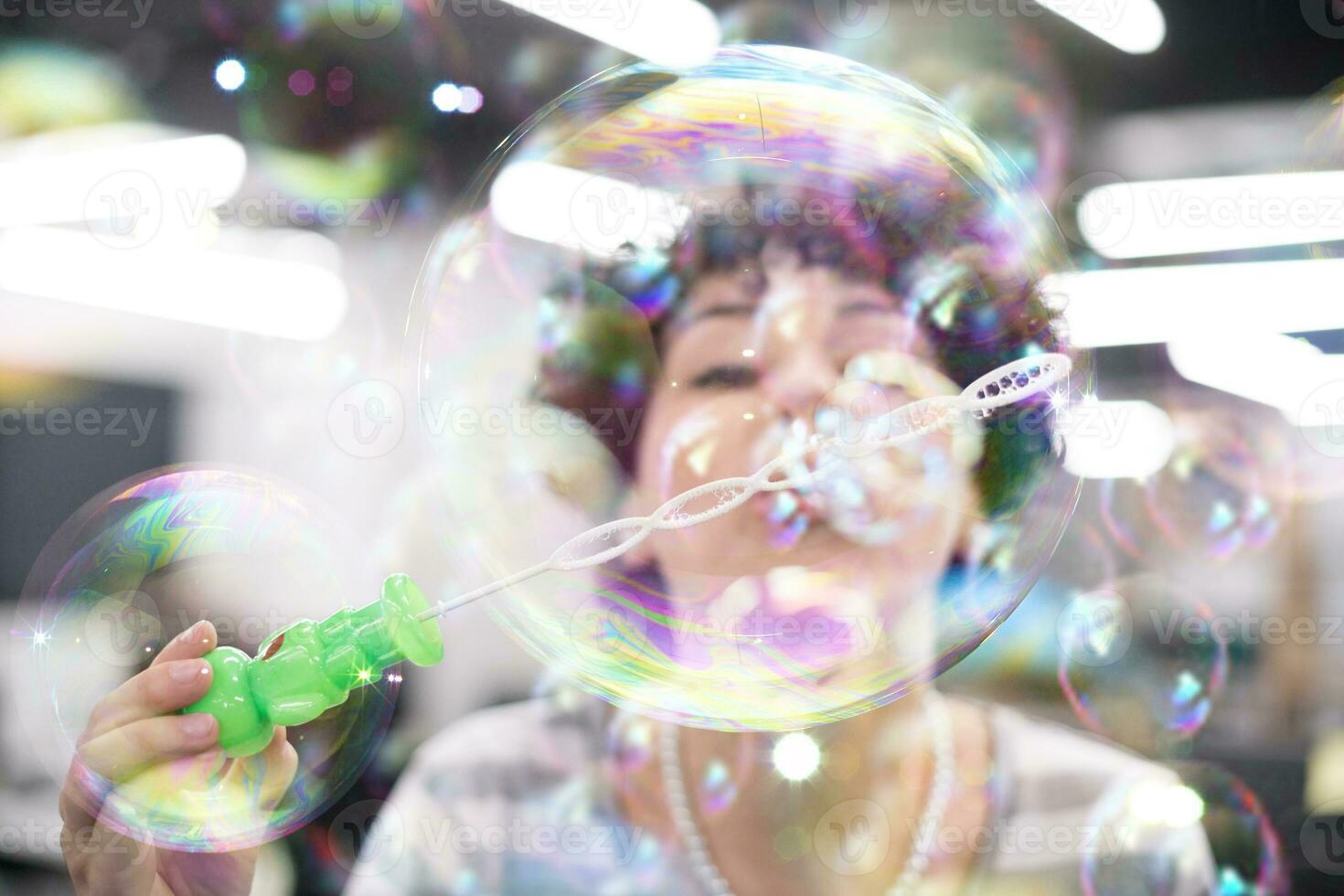 software developer having fun while making soap bubble photo