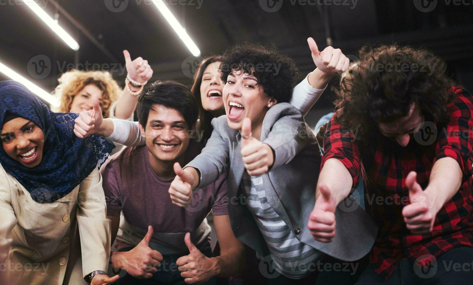 portrait of young excited multiethnics business team photo