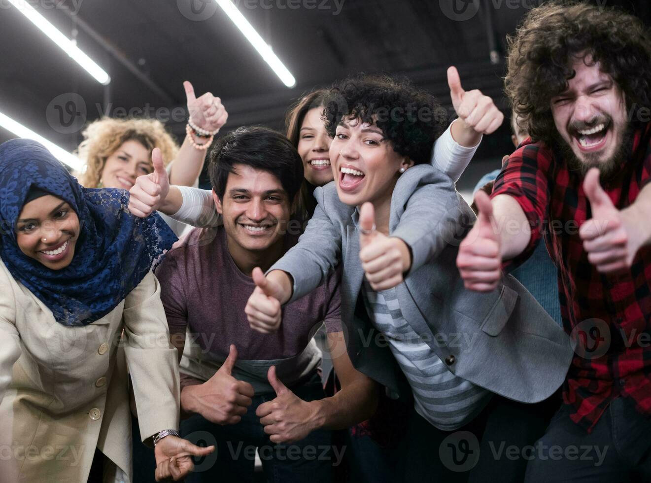 portrait of young excited multiethnics business team photo