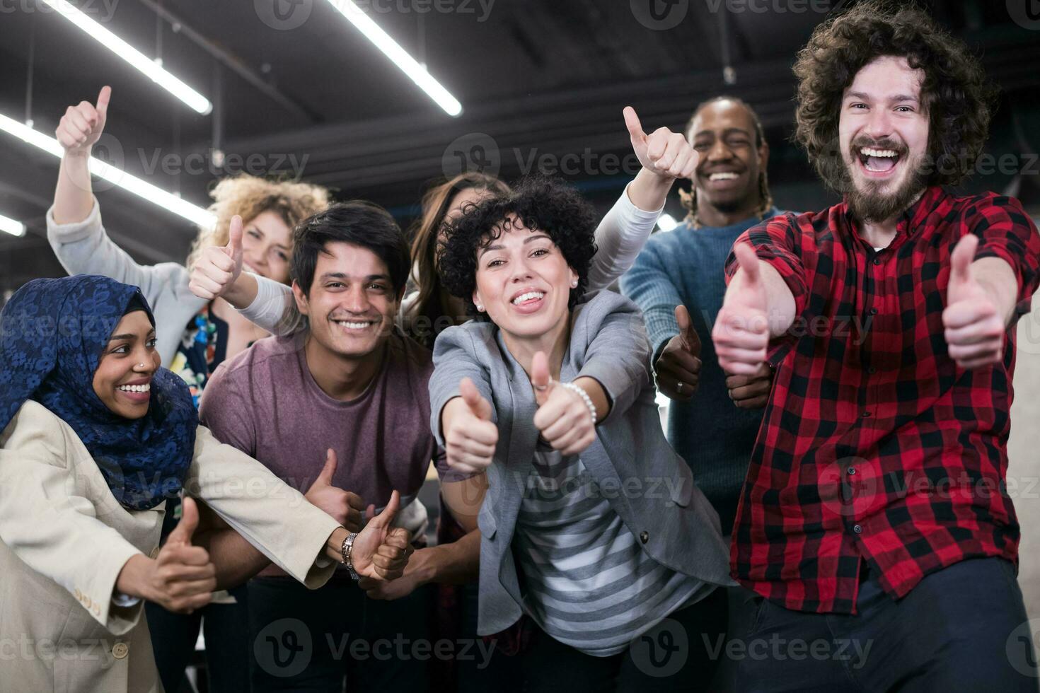 portrait of young excited multiethnics business team photo