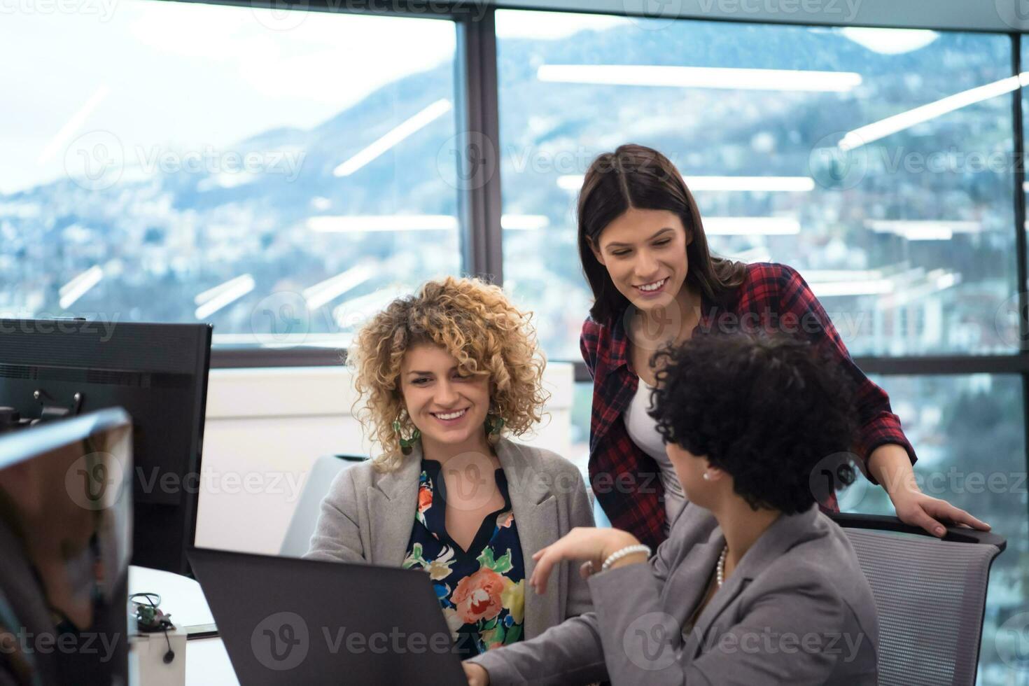 female software developers using laptop computer photo