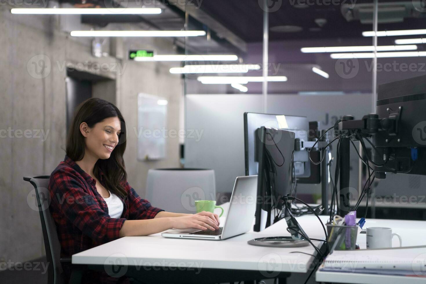 female software developer using laptop computer photo