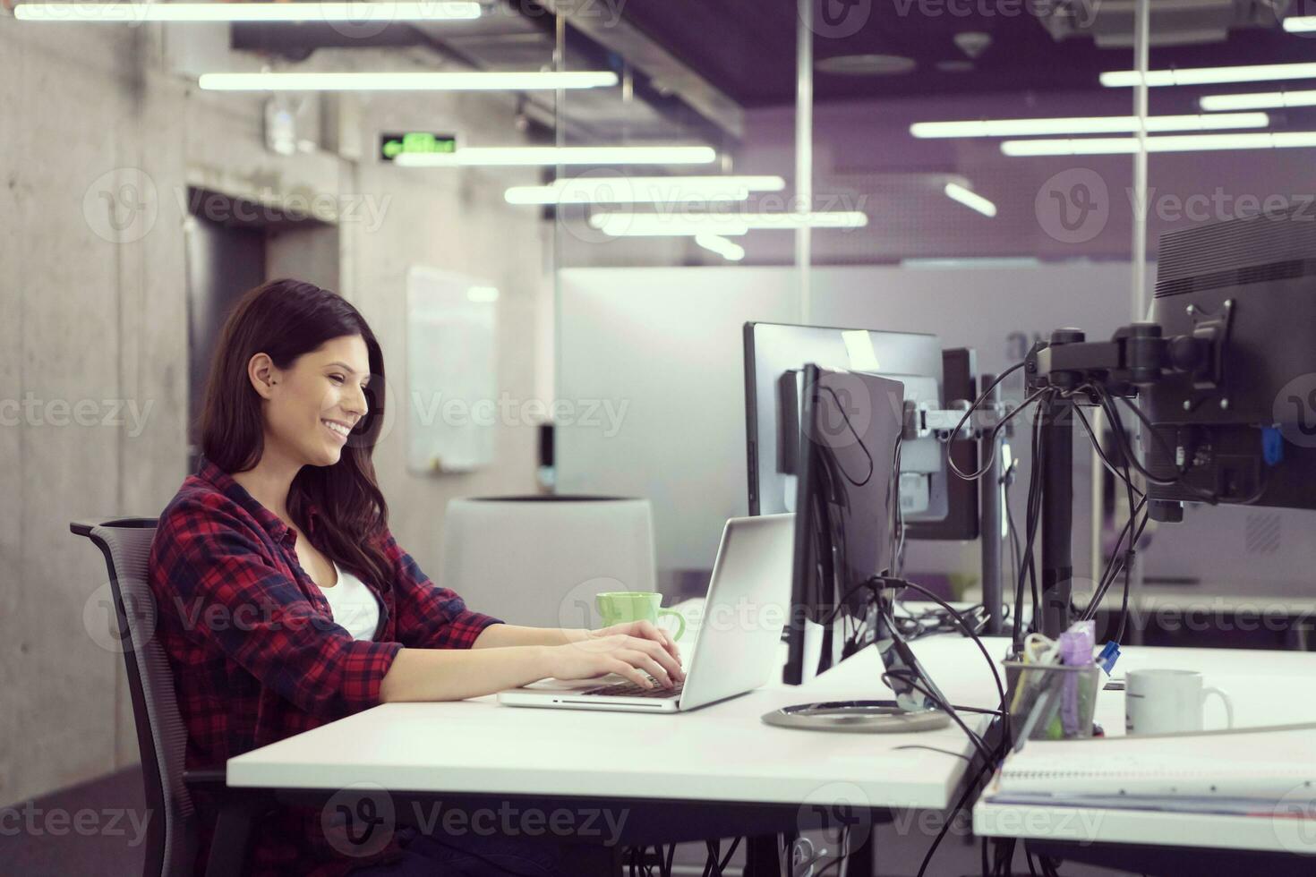 female software developer using laptop computer photo