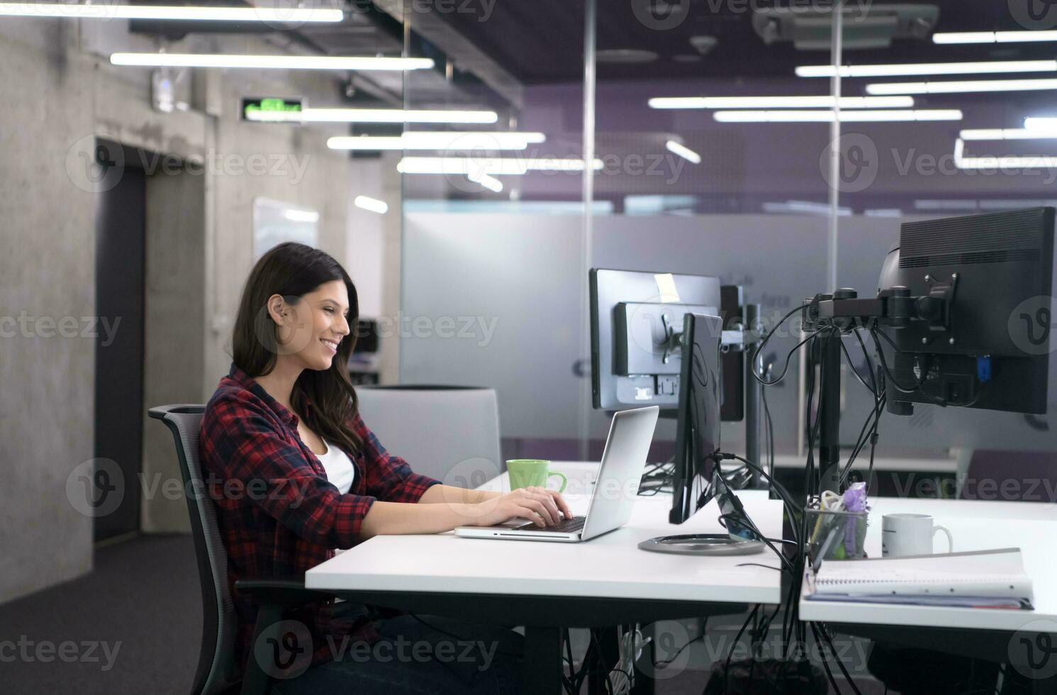 female software developer using laptop computer photo