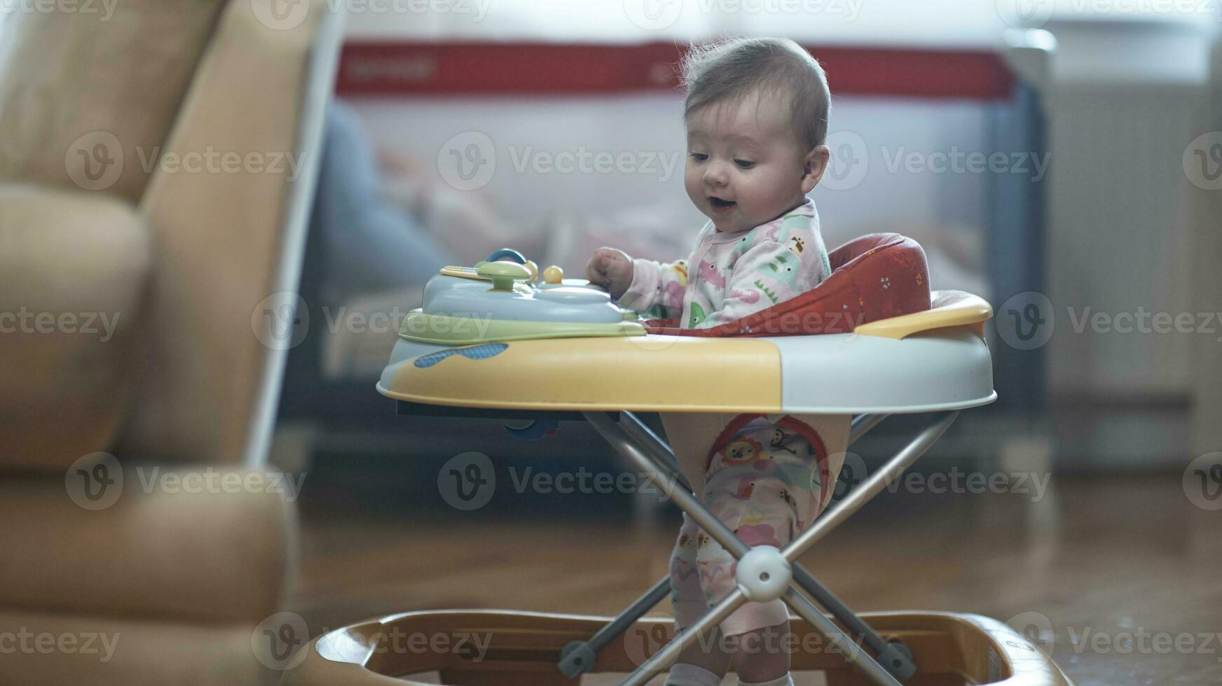 baby learning to walk in walker photo