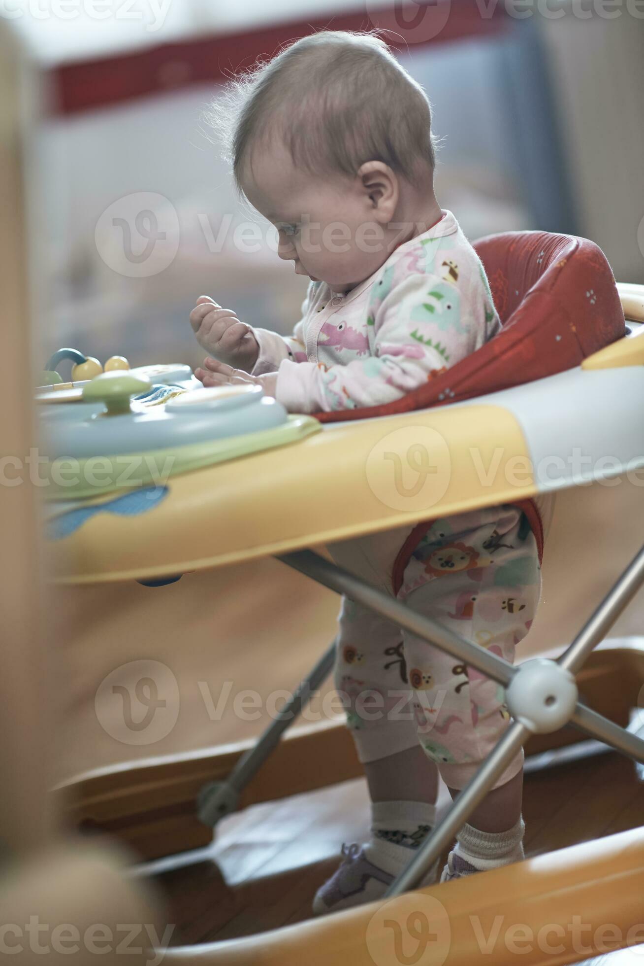 baby learning to walk in walker 31023327 Stock Photo at Vecteezy