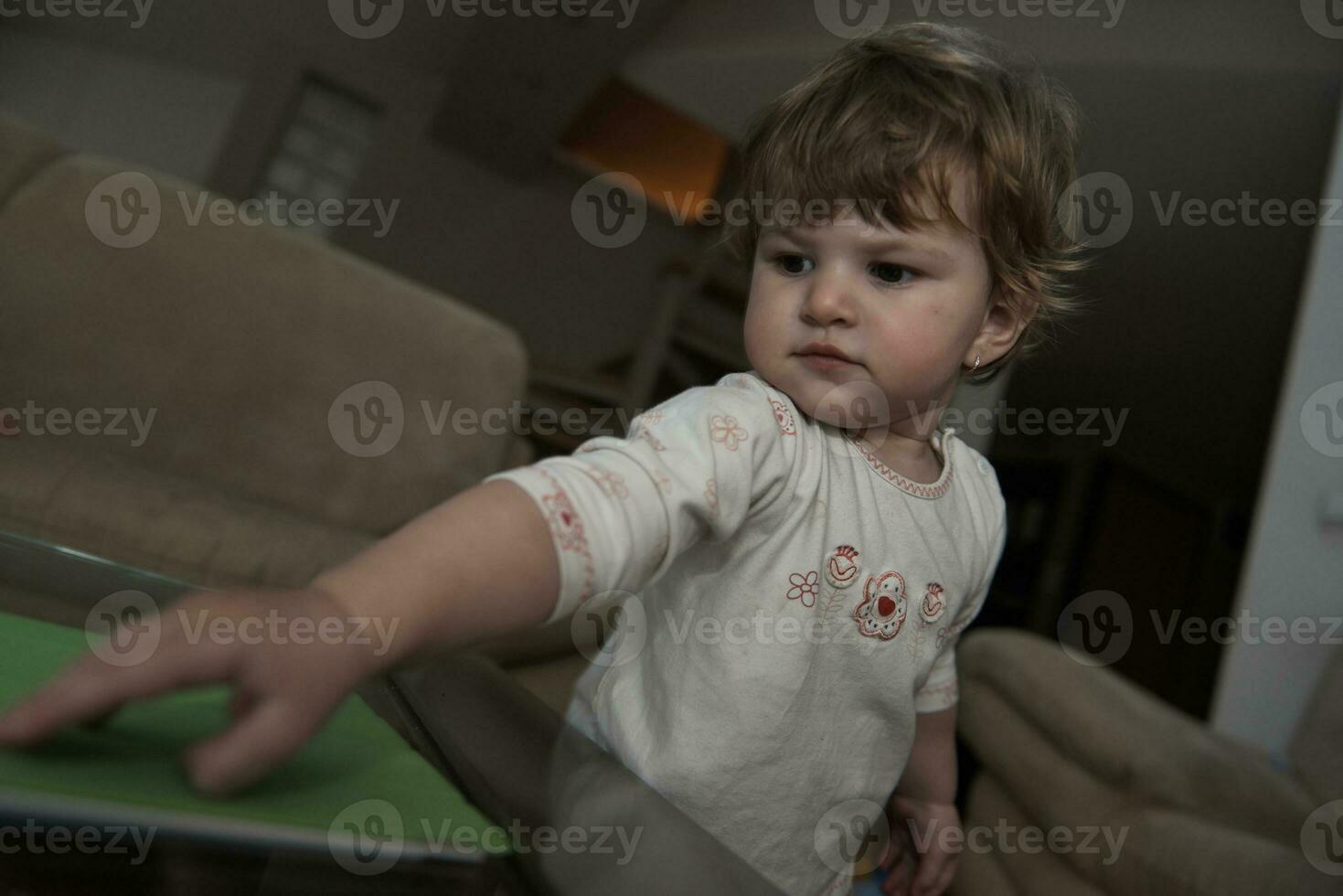 Adorable cute beautiful little baby girl playing with toys at home photo