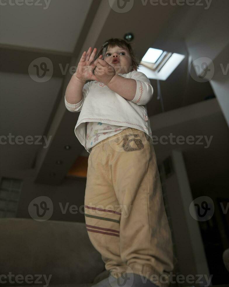 Adorable cute beautiful little baby girl playing with toys at home photo