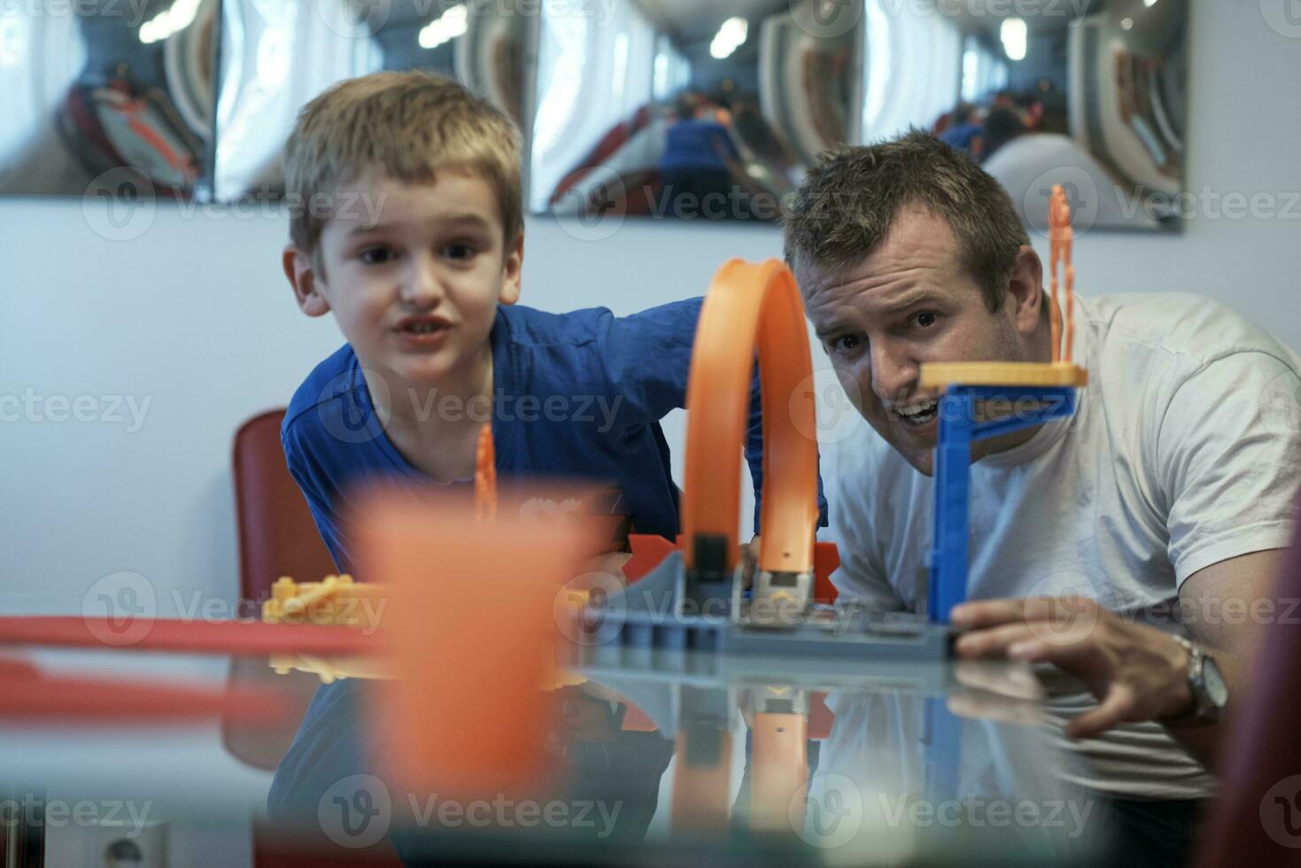 Father and children playing car toy game photo