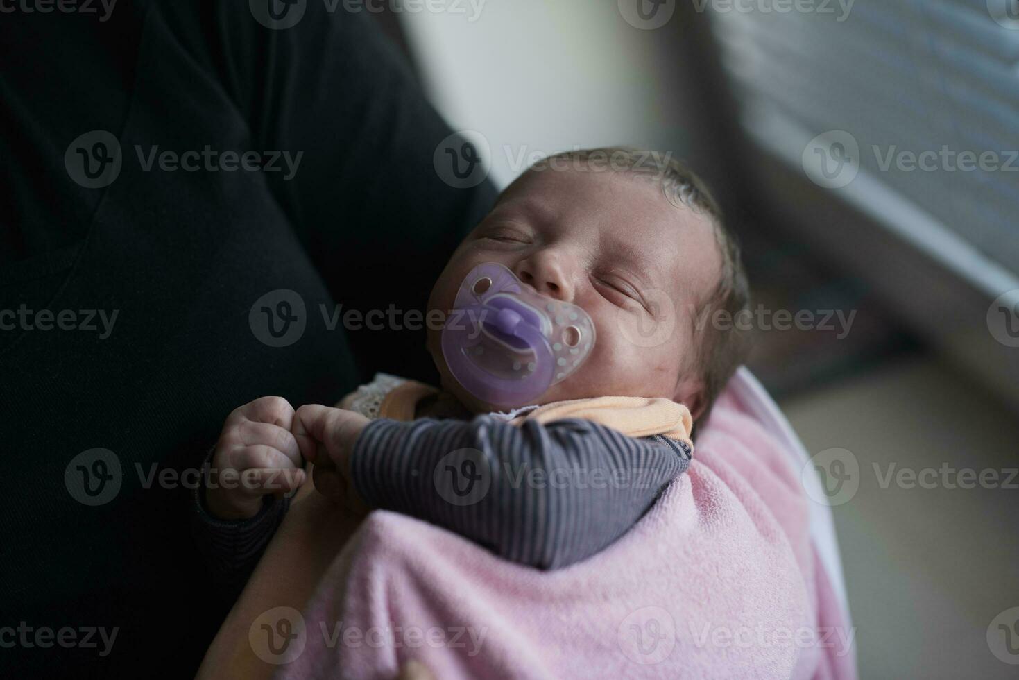 grandmother holding newborn baby at home photo