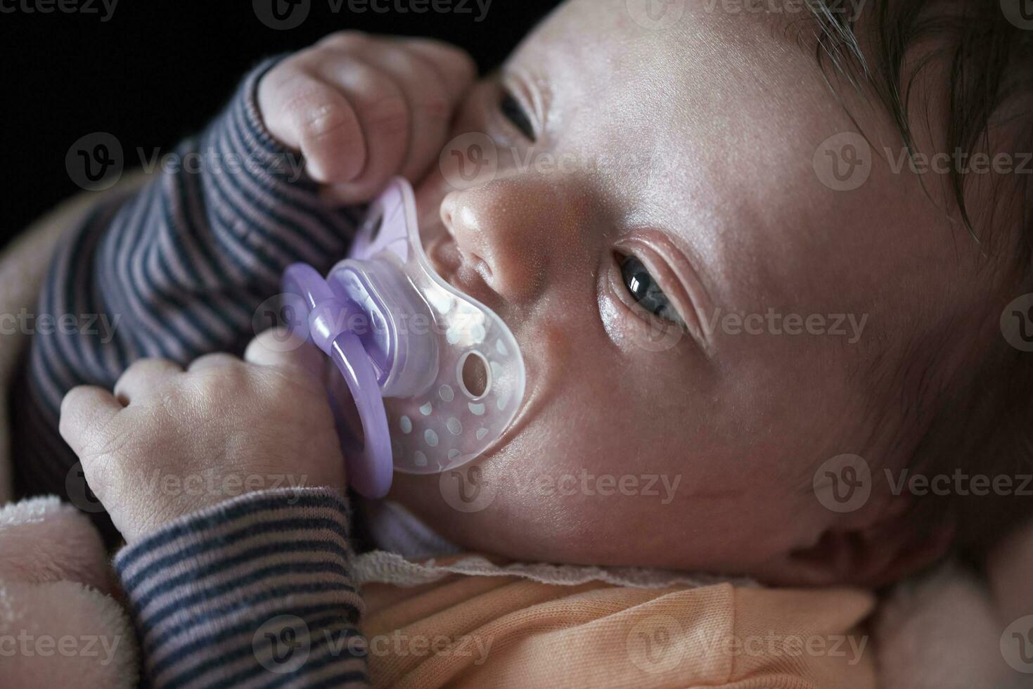 One month newborn baby sleeping  in bed photo