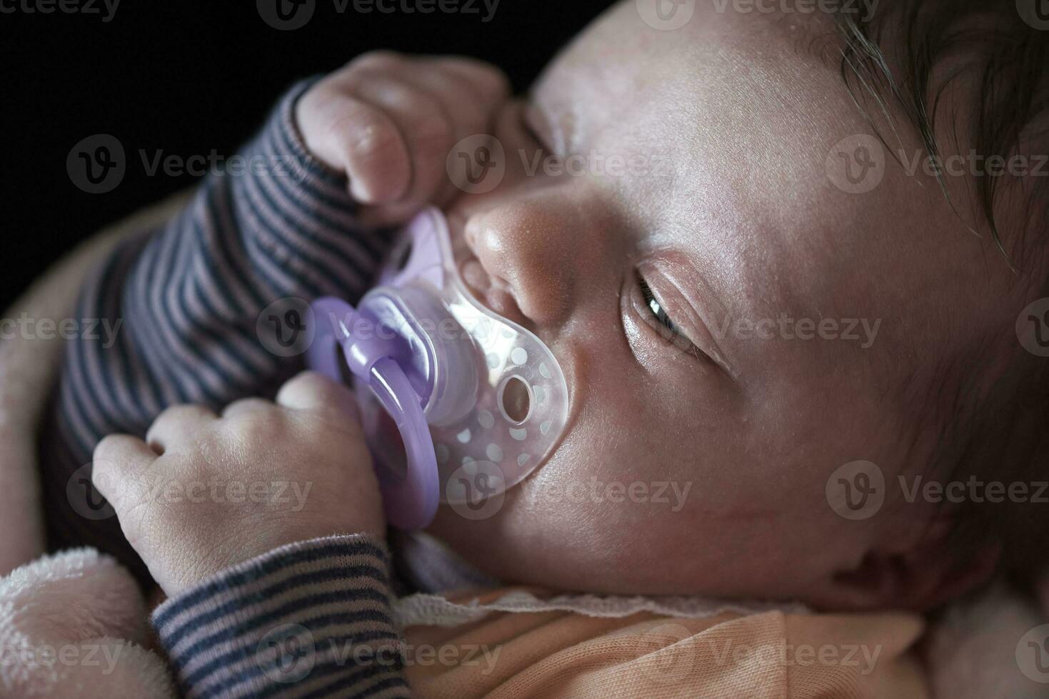 One month newborn baby sleeping  in bed photo