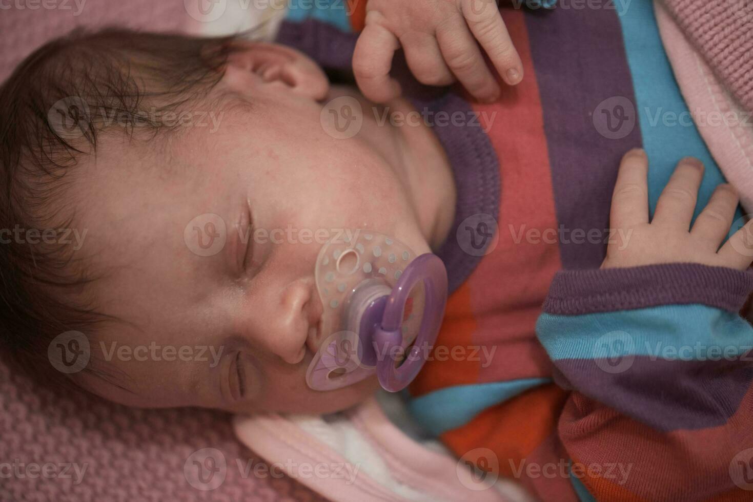 One month newborn baby sleeping  in bed photo