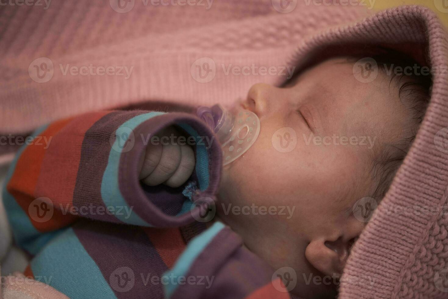 One month newborn baby sleeping  in bed photo