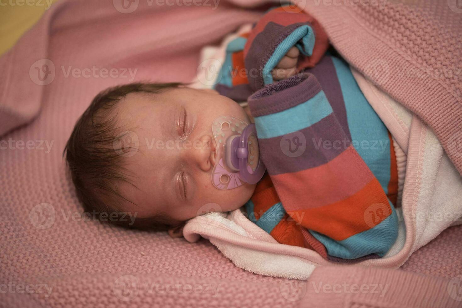 One month newborn baby sleeping  in bed photo