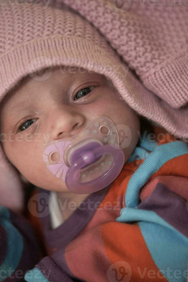 One month newborn baby sleeping  in bed photo