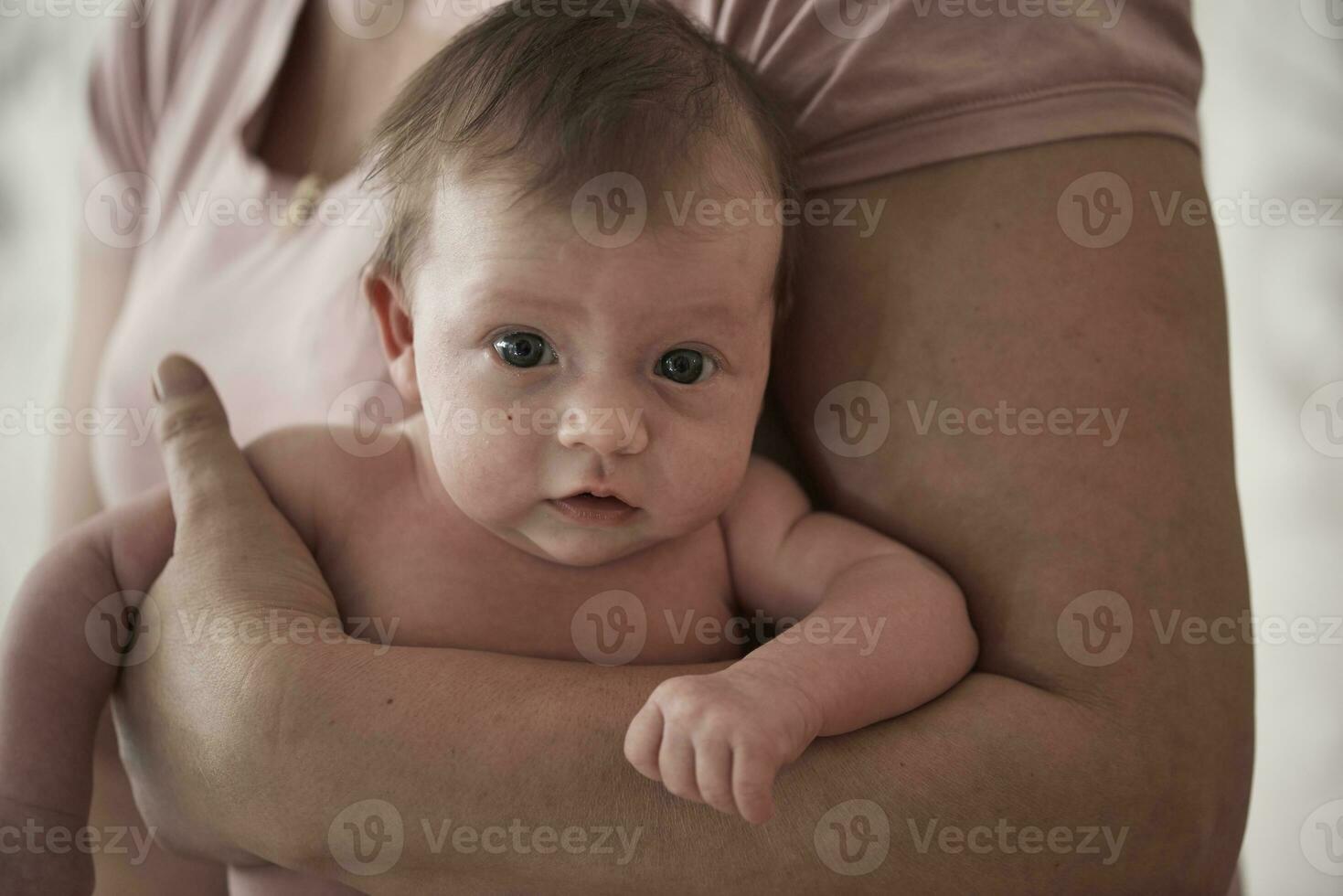 Newborn baby girl taking a  bath photo