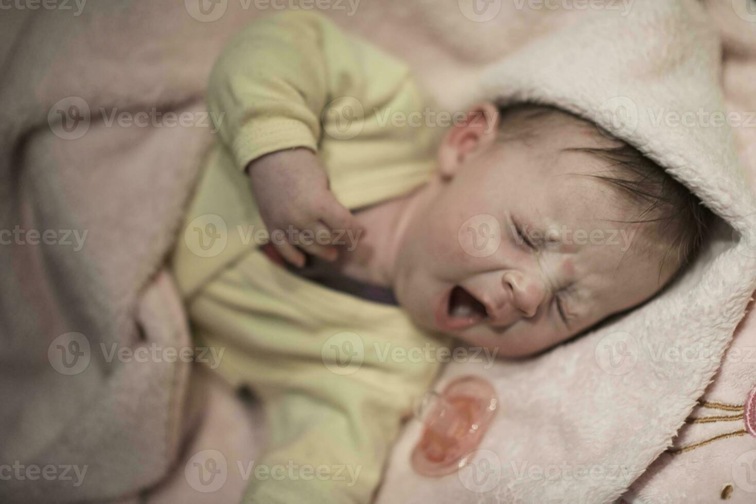 newborn baby sleeping  at home in bed photo