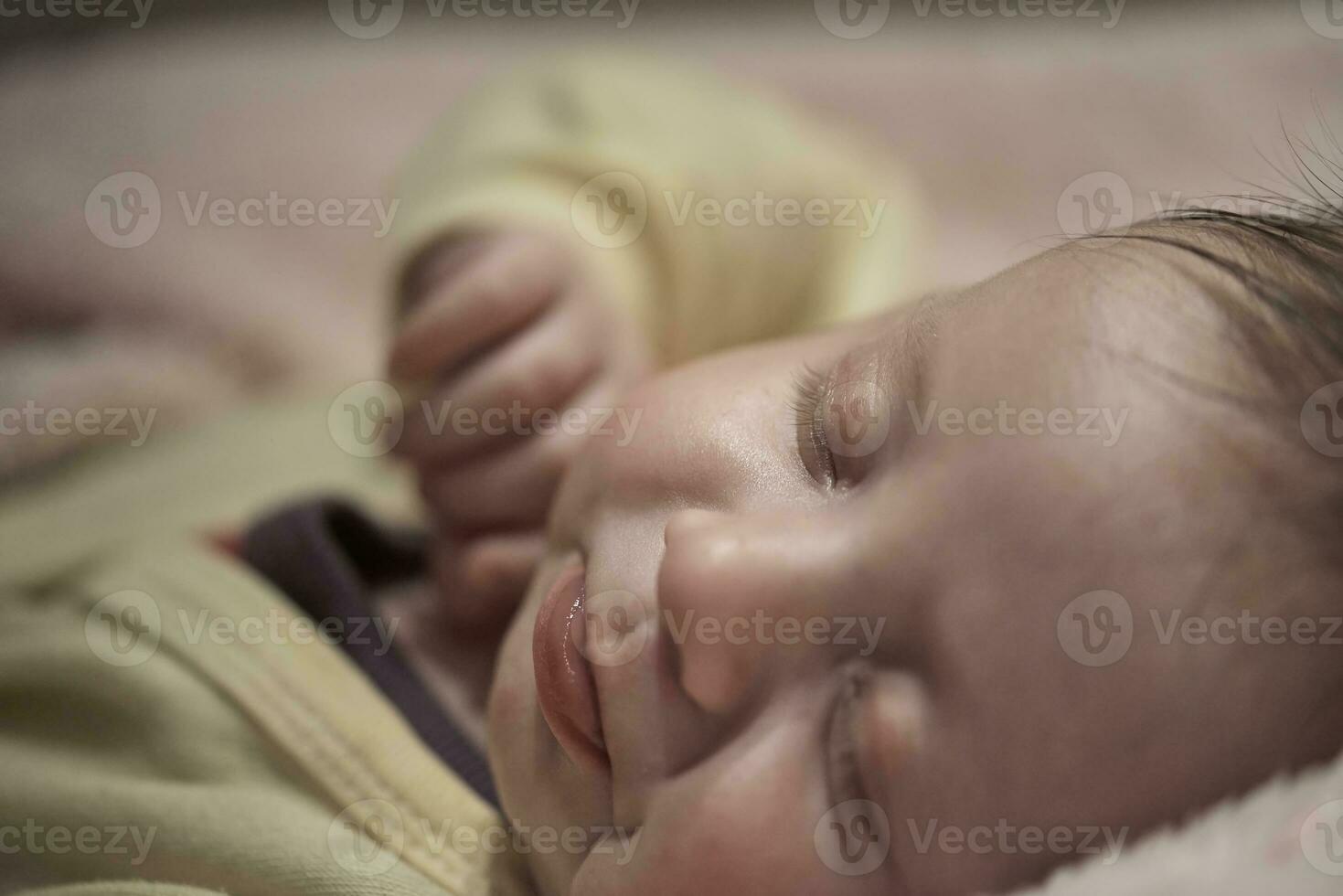 newborn baby sleeping  at home in bed photo
