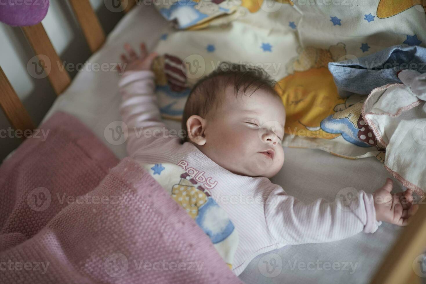 newborn baby sleeping  at home in bed photo