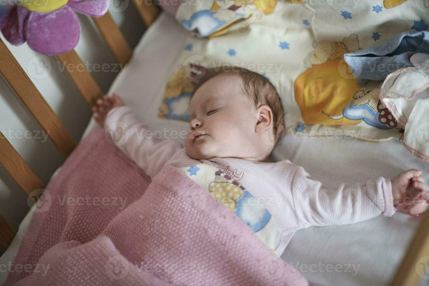 newborn baby sleeping  at home in bed photo