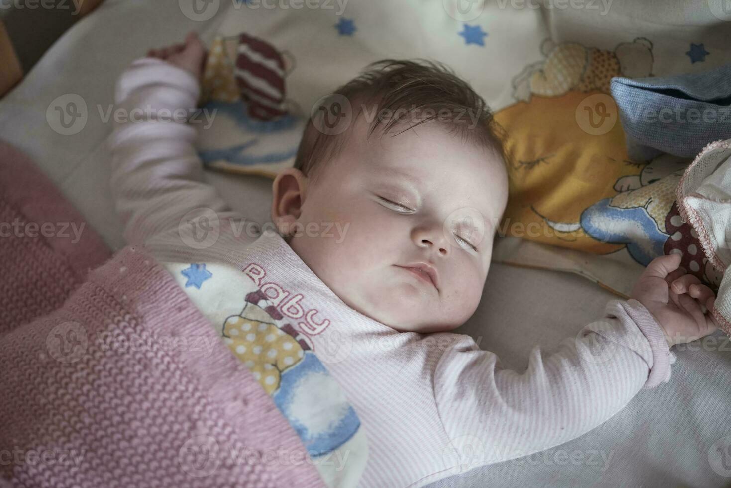 newborn baby sleeping  at home in bed photo