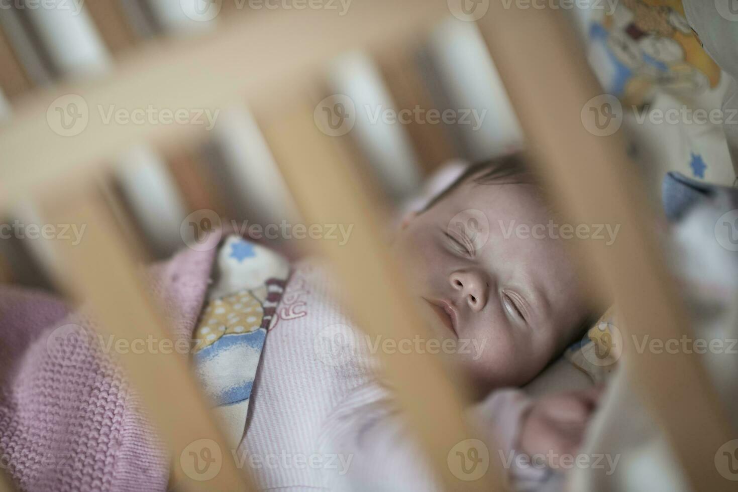newborn baby sleeping  at home in bed photo