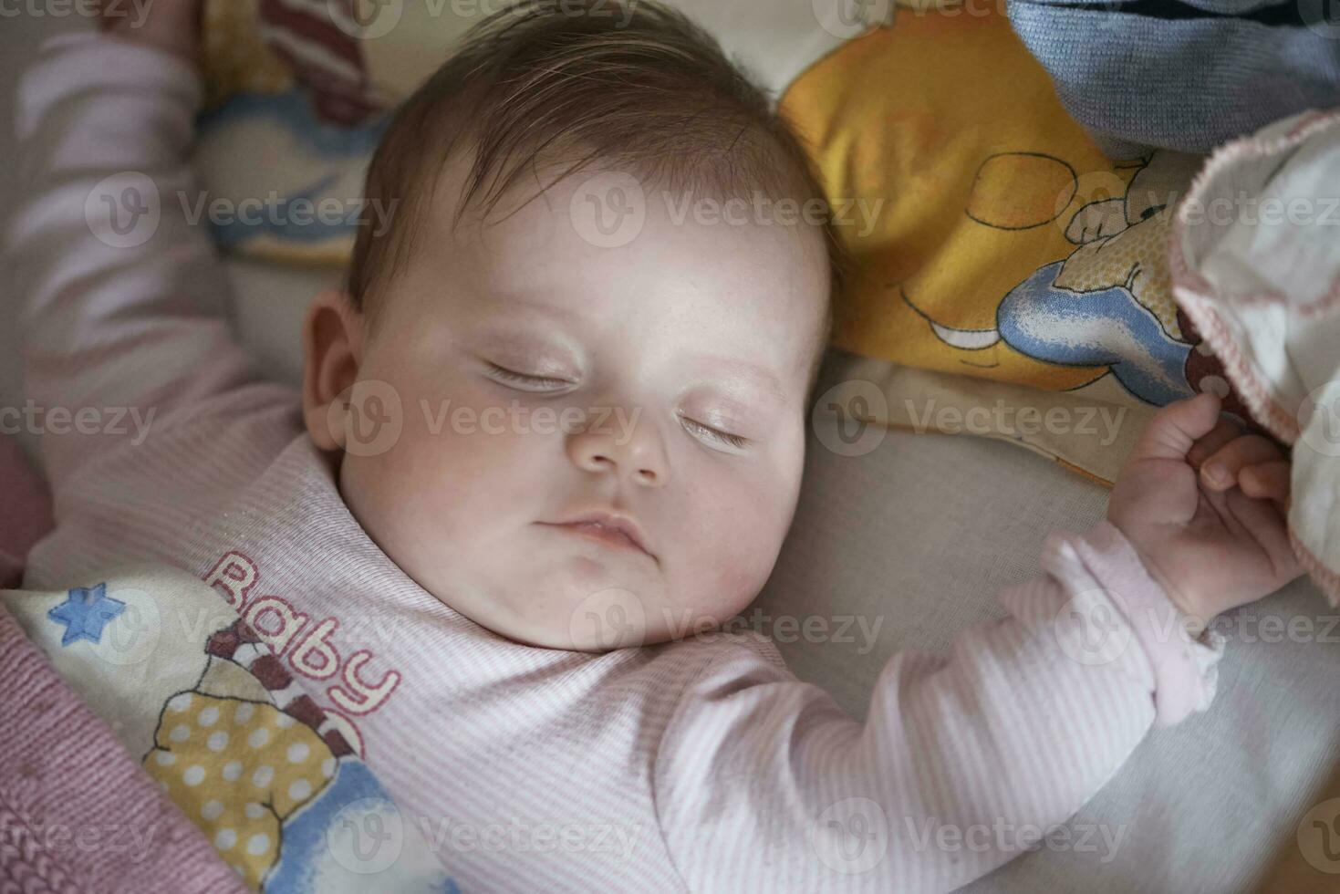 newborn baby sleeping  at home in bed photo