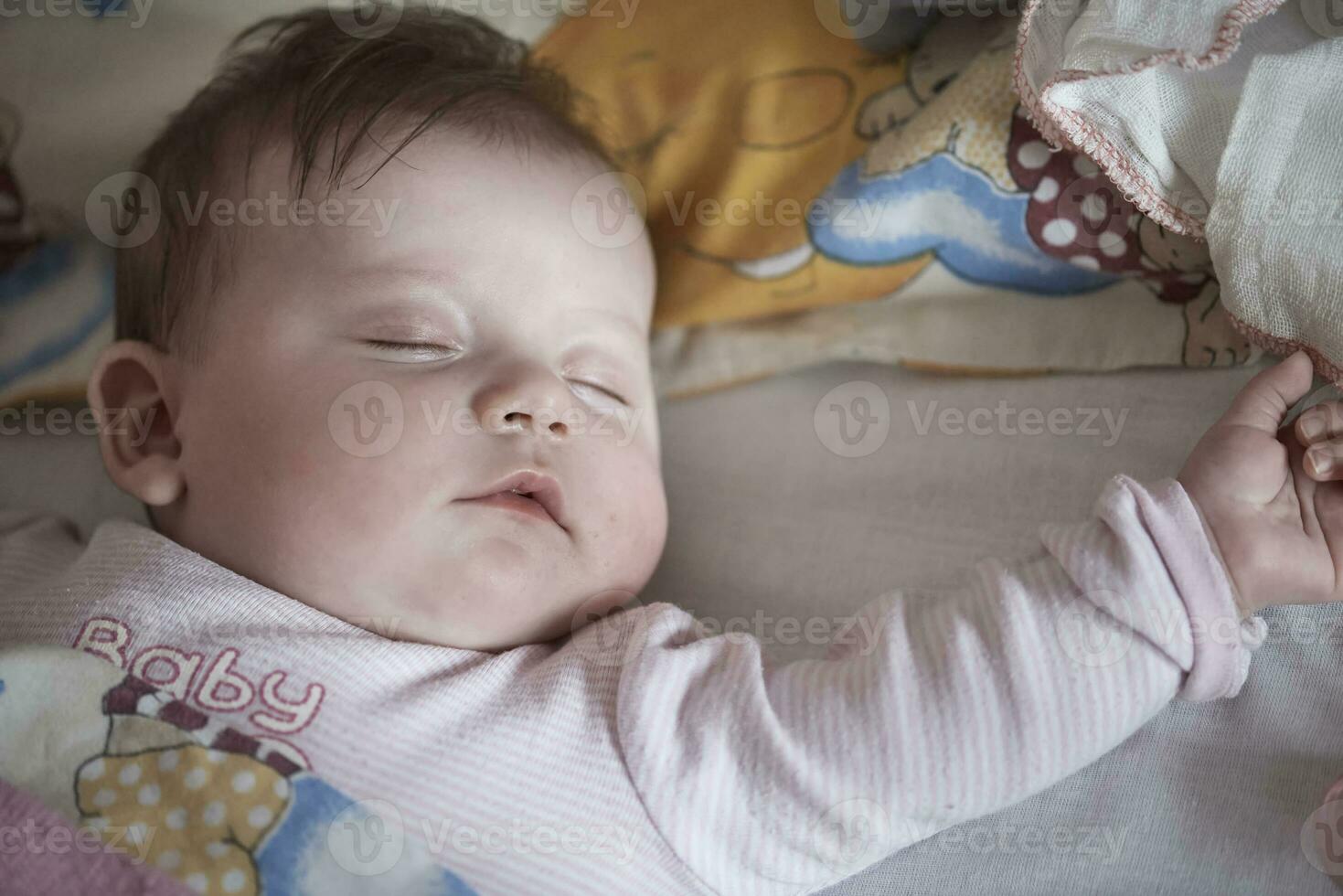 newborn baby sleeping  at home in bed photo