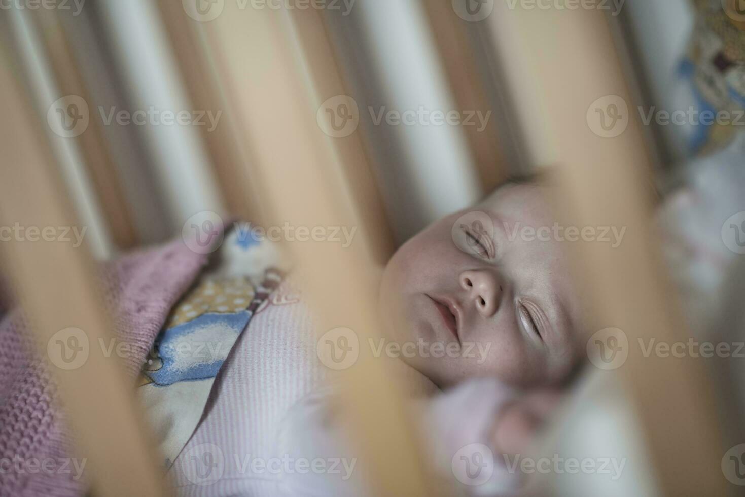 newborn baby sleeping  at home in bed photo