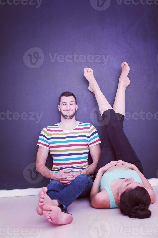 pregnant couple relaxing on the floor photo