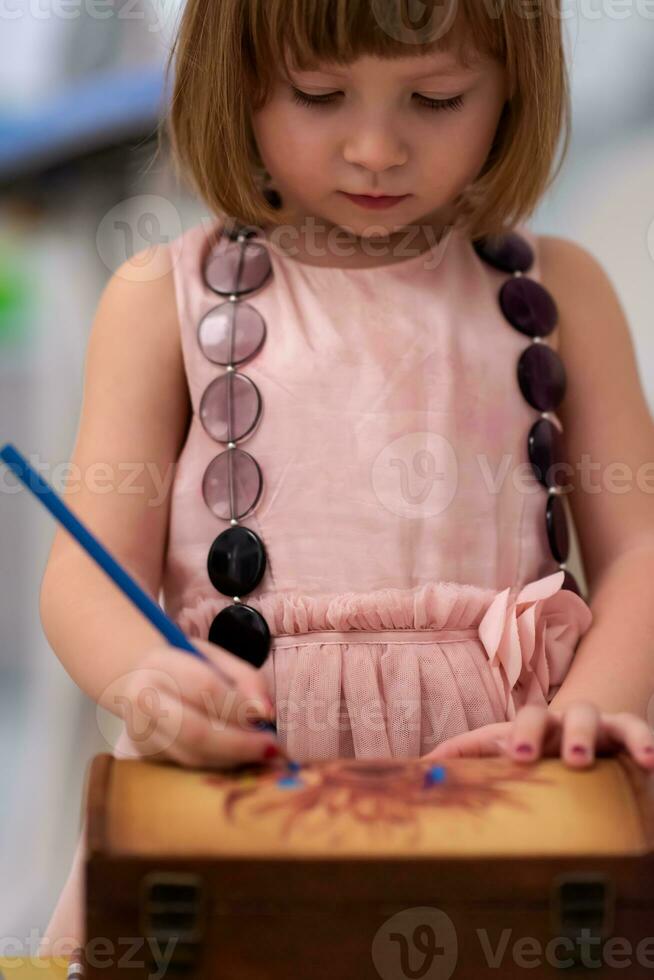 little girl painting jewelry box photo