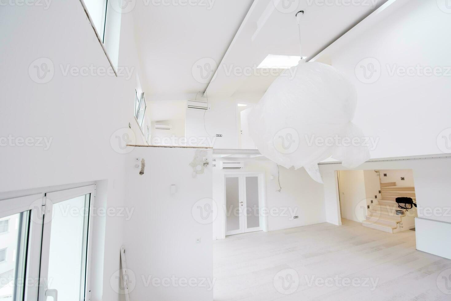 Interior of empty stylish modern open space two level apartment photo
