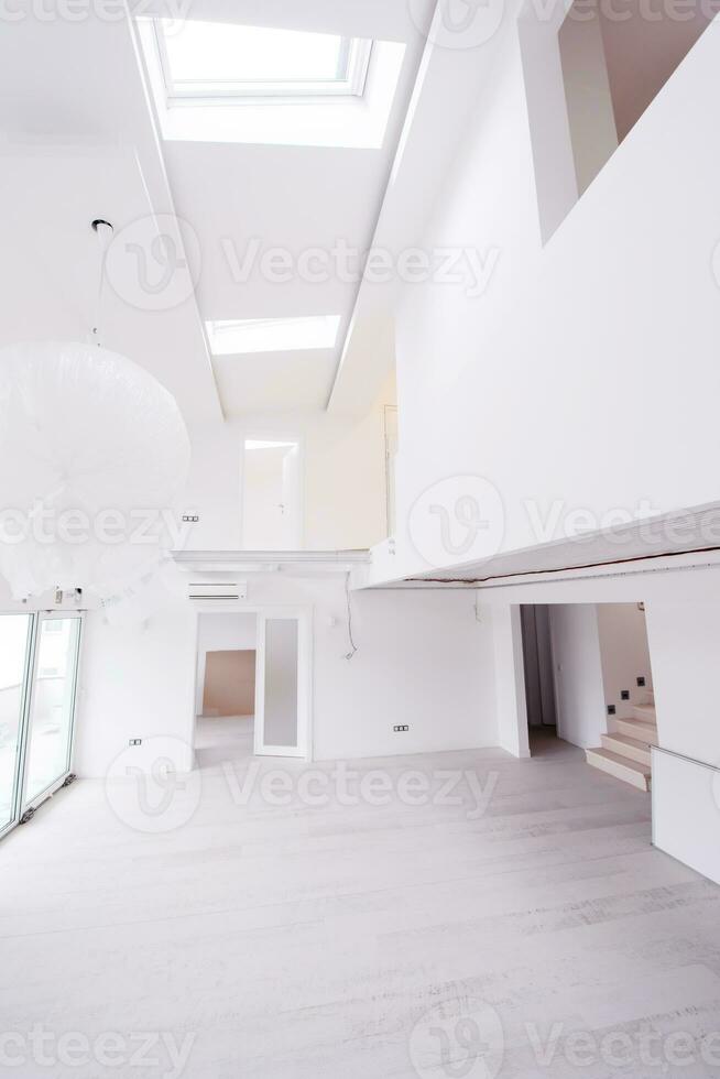 Interior of empty stylish modern open space two level apartment photo