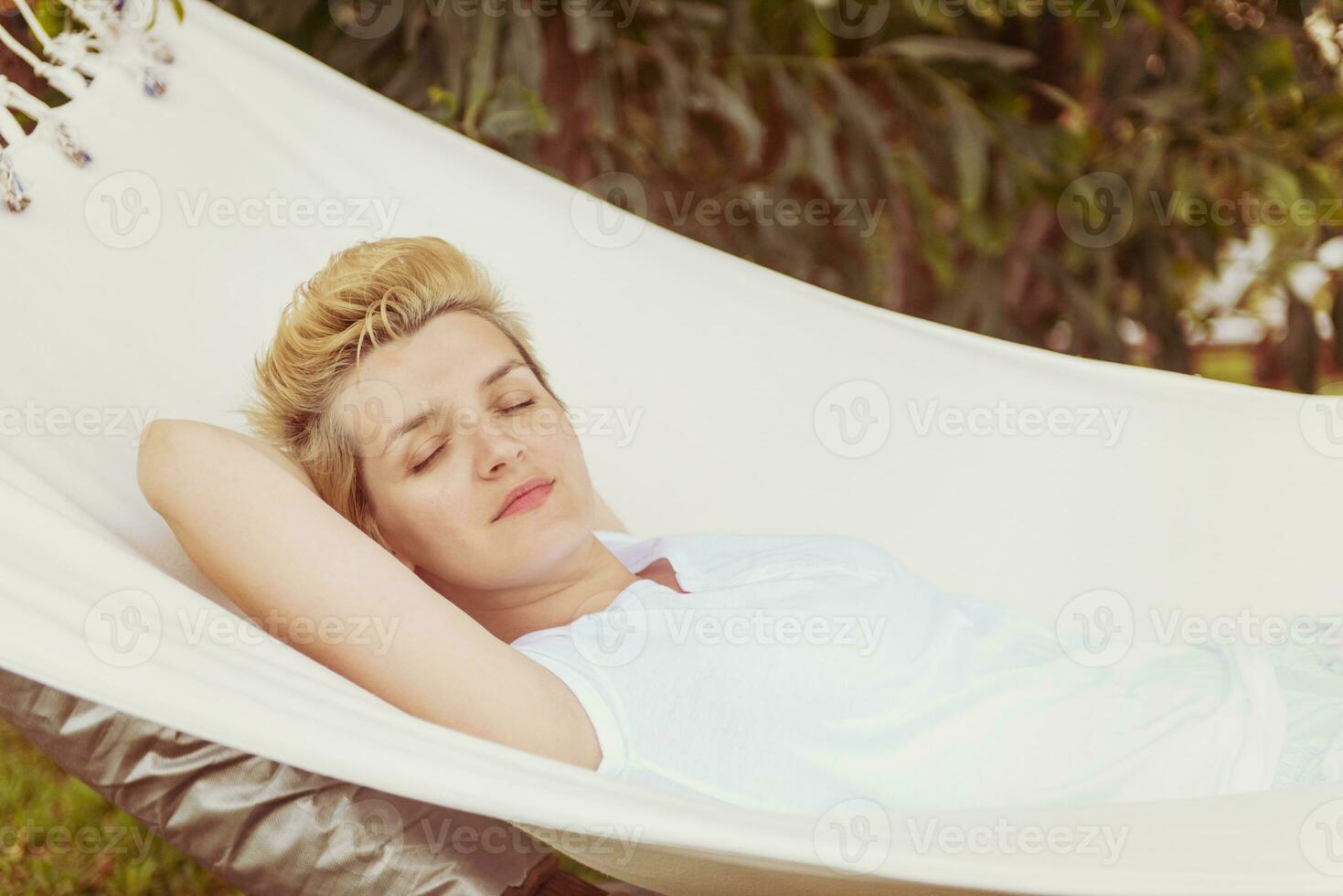 young woman resting on hammock photo