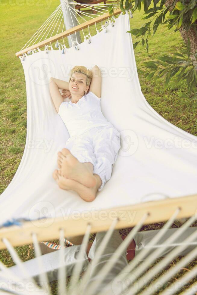 young woman resting on hammock photo