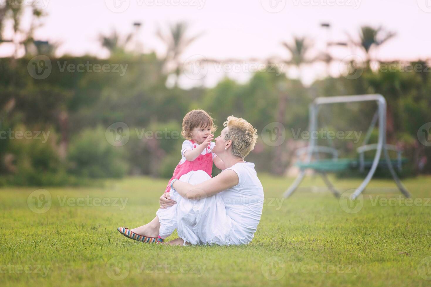 mother and little daughter playing at backyard photo