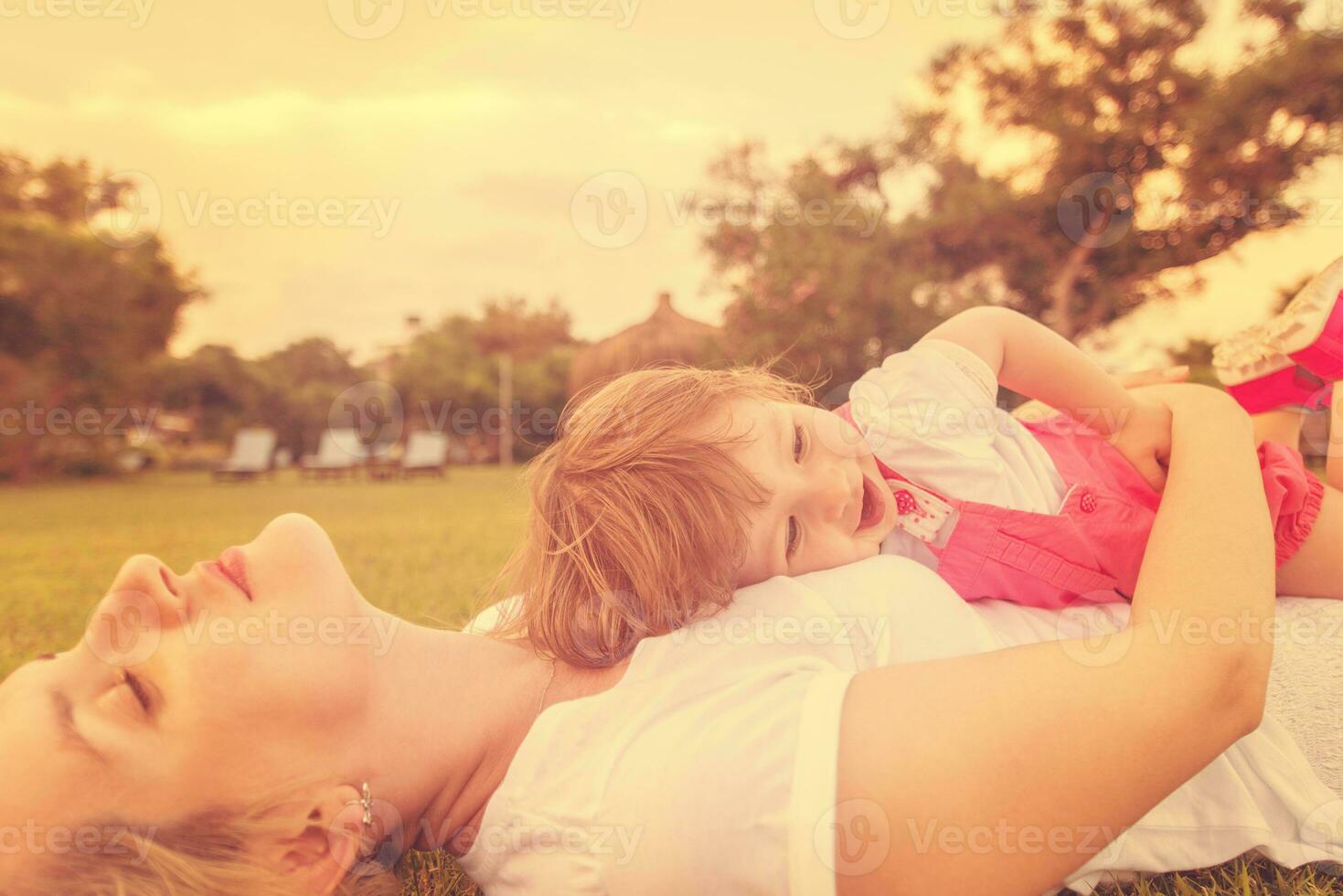 mother and little daughter playing at backyard photo