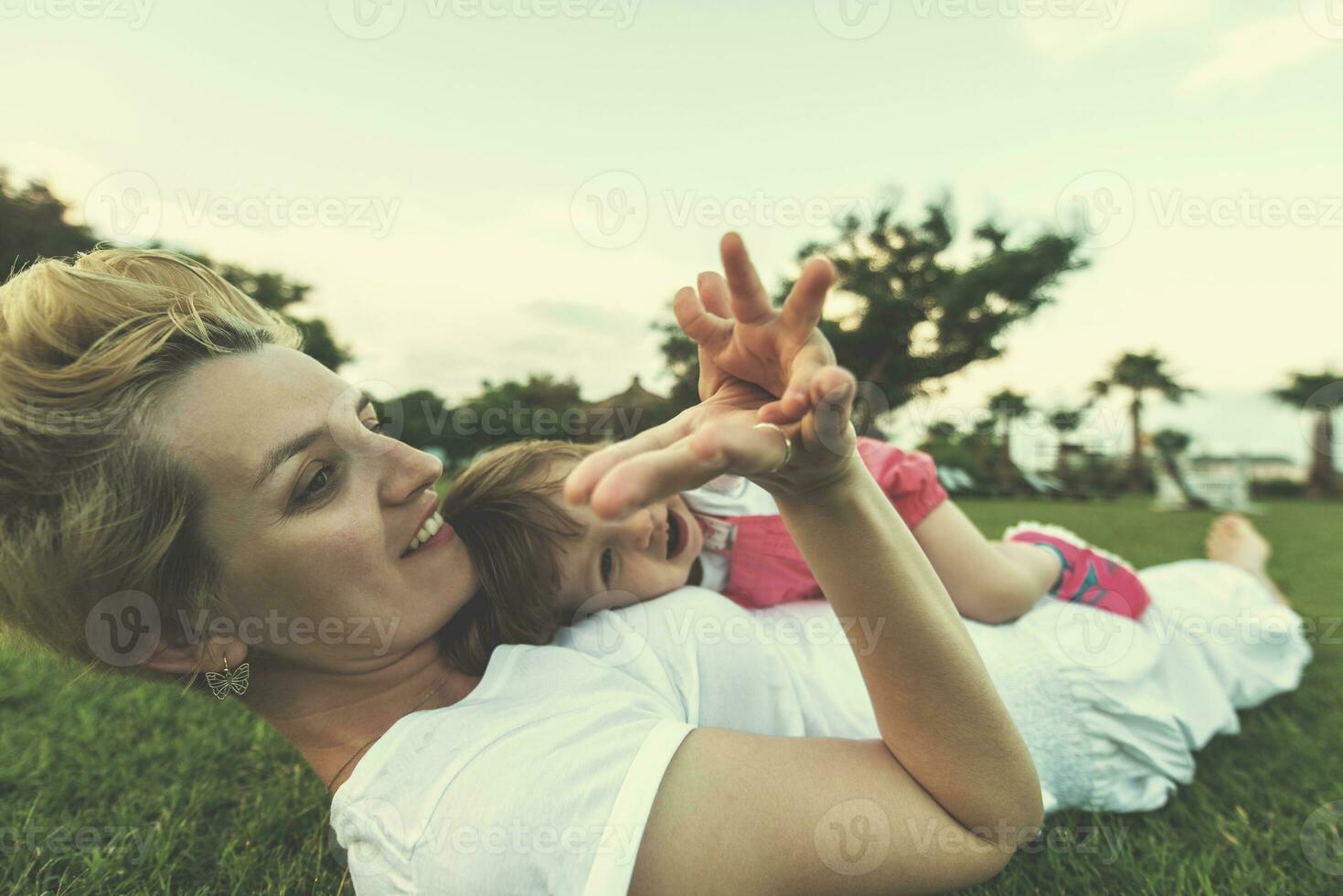 mother and little daughter playing at backyard photo