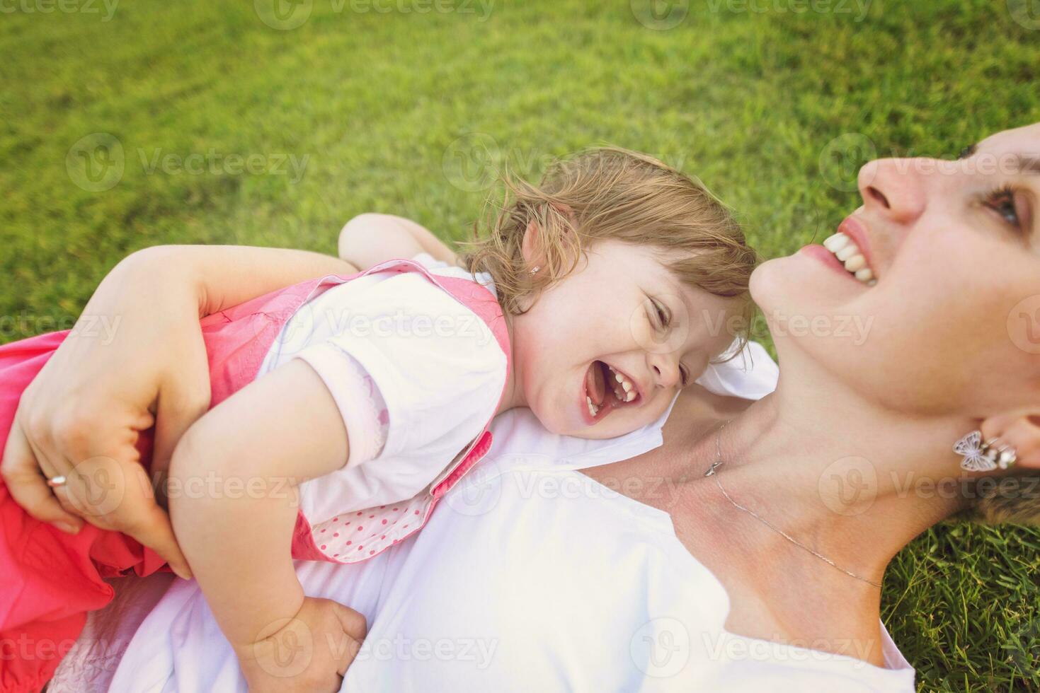 mother and little daughter playing at backyard photo