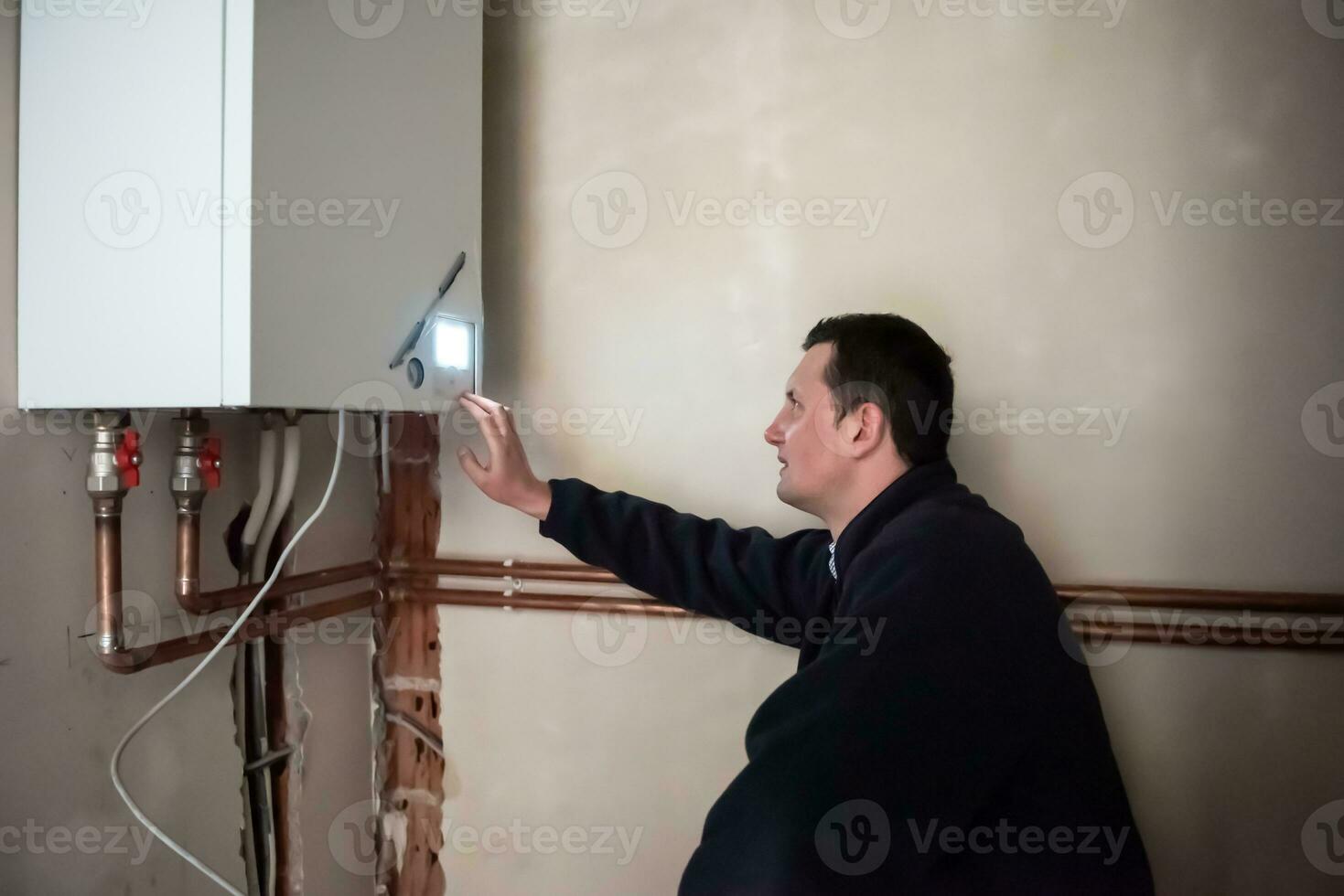 engineer checking technical data of heating system photo