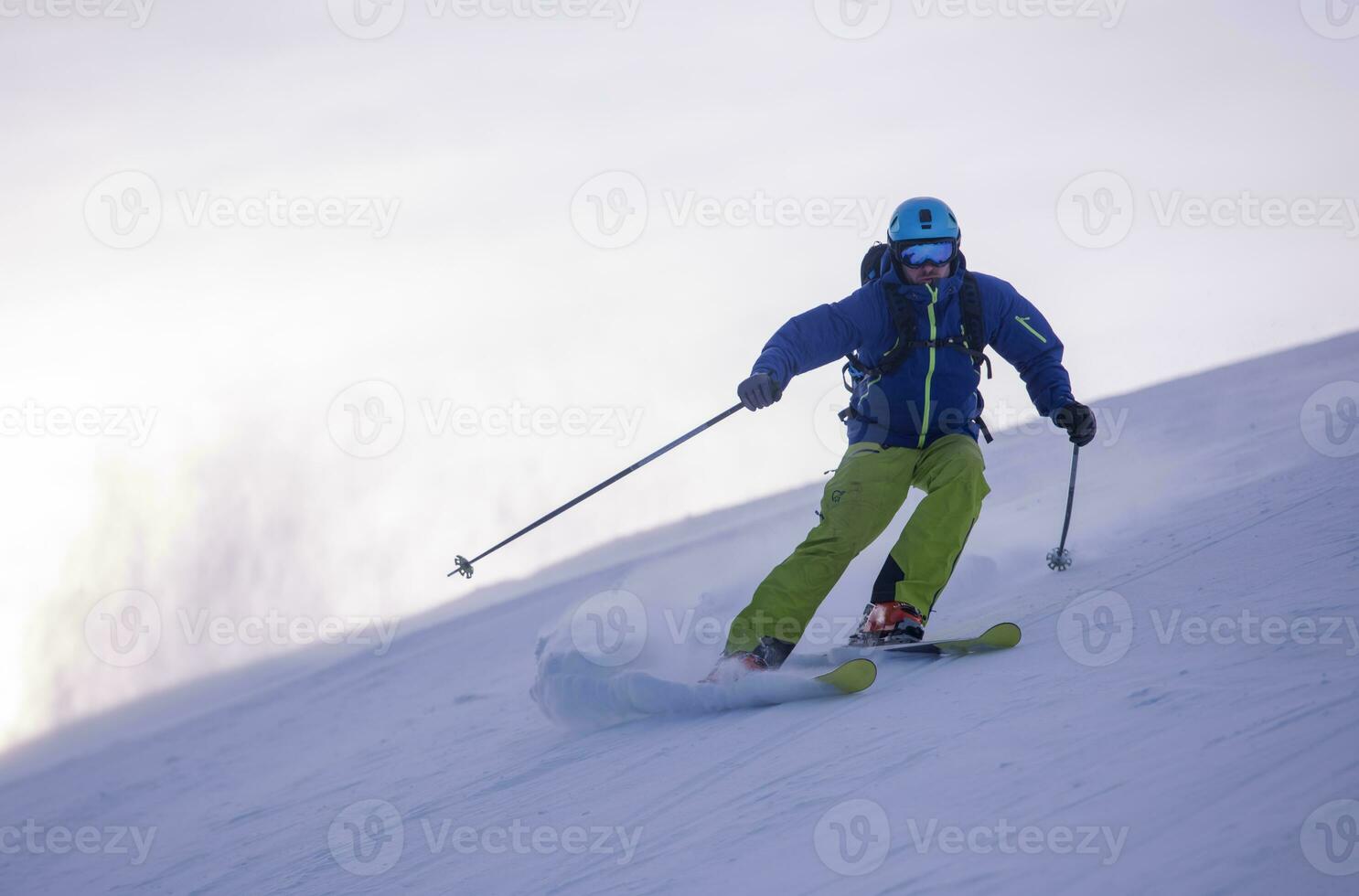 Skier having fun while running downhill photo