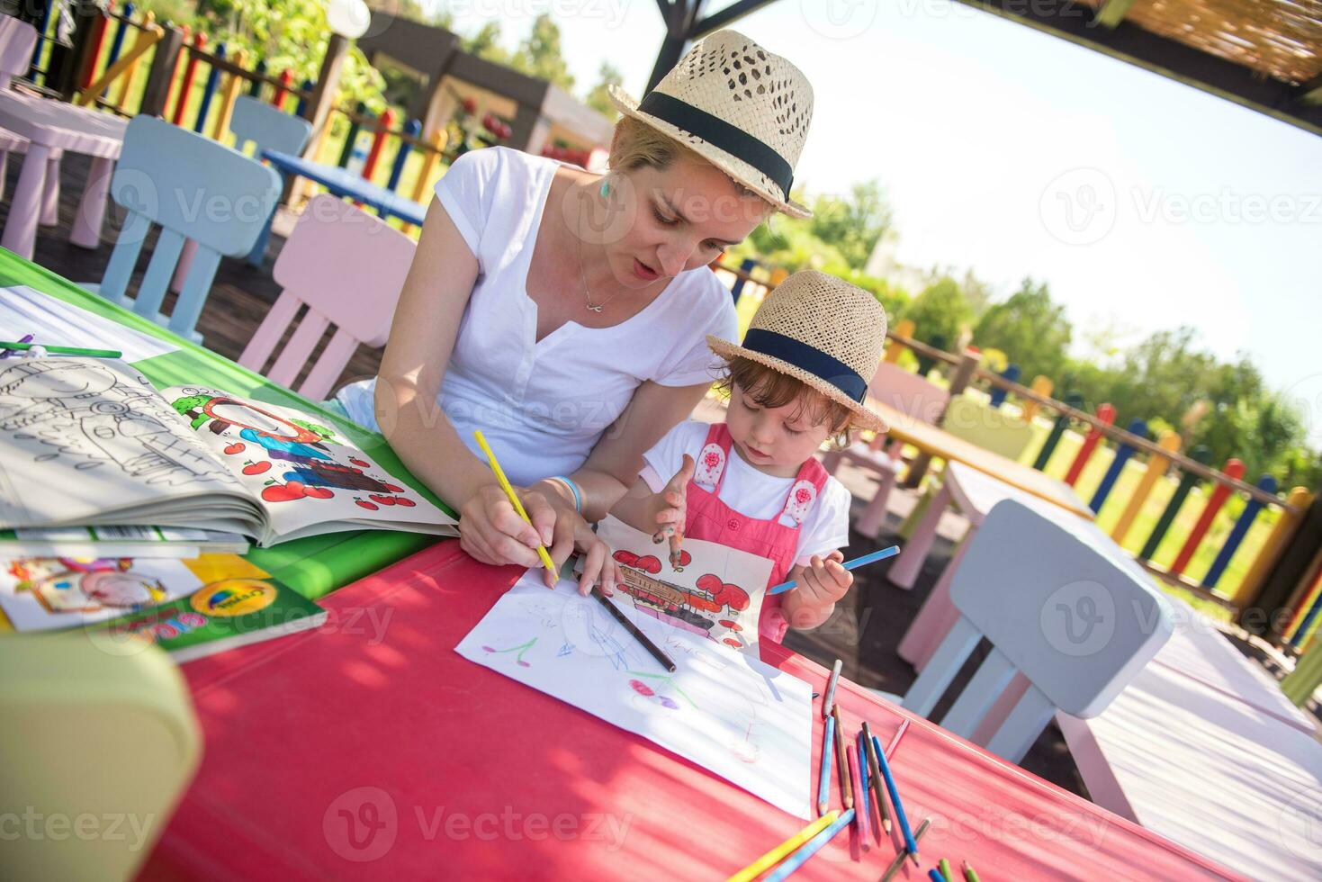 mom and little daughter drawing a colorful pictures photo