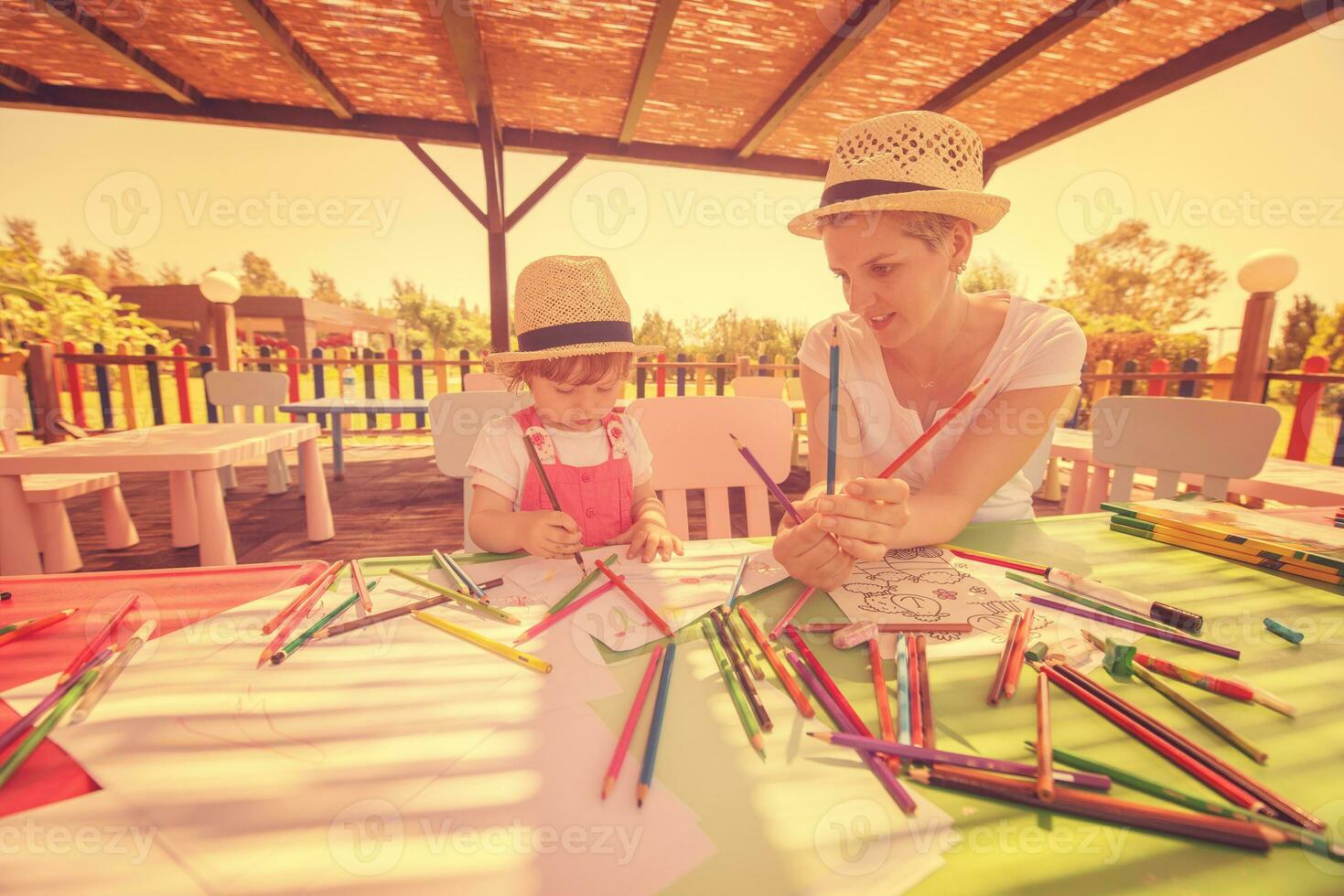 mom and little daughter drawing a colorful pictures photo