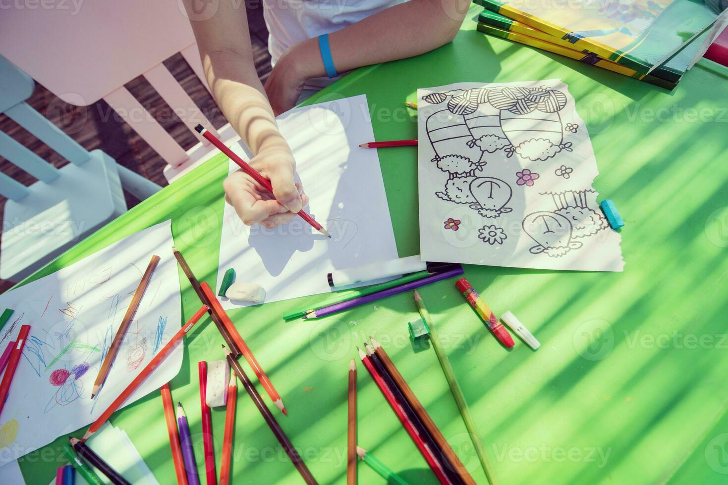 closeup of hands drawing a colorful pictures photo
